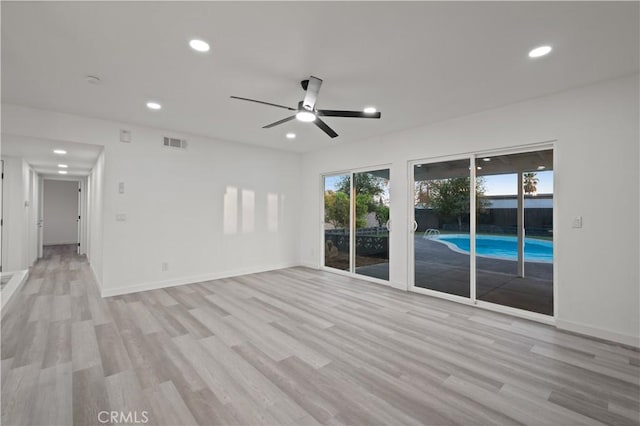 spare room with light hardwood / wood-style floors and ceiling fan