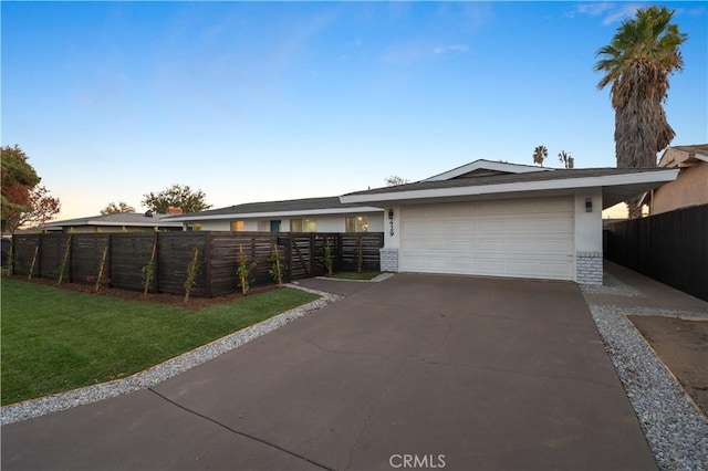 view of front facade with a garage and a yard