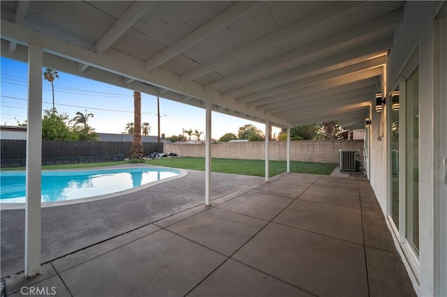 view of swimming pool with a patio, a lawn, and central air condition unit