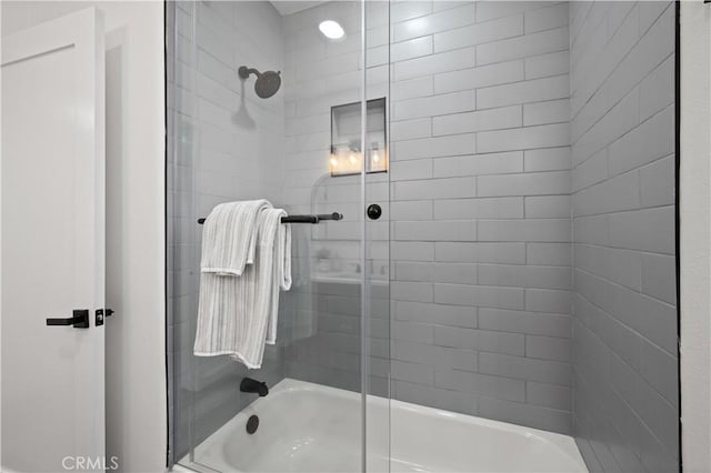 bathroom featuring shower / bath combination with glass door