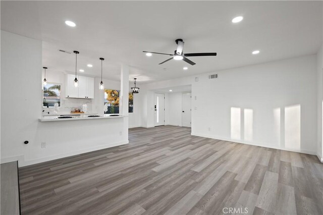 unfurnished living room with light hardwood / wood-style floors and ceiling fan