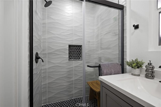 bathroom with vanity and a shower with shower door