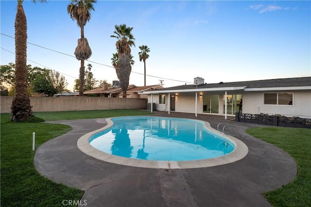 view of pool featuring a yard and a patio