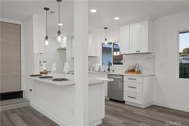 kitchen featuring dishwasher, sink, hardwood / wood-style floors, pendant lighting, and white cabinets