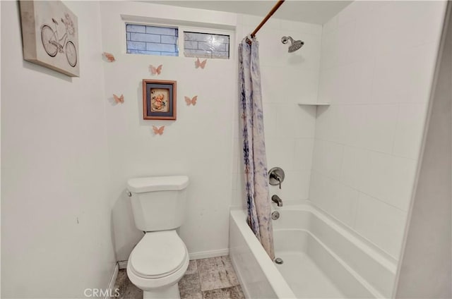 bathroom featuring toilet and shower / bath combo with shower curtain