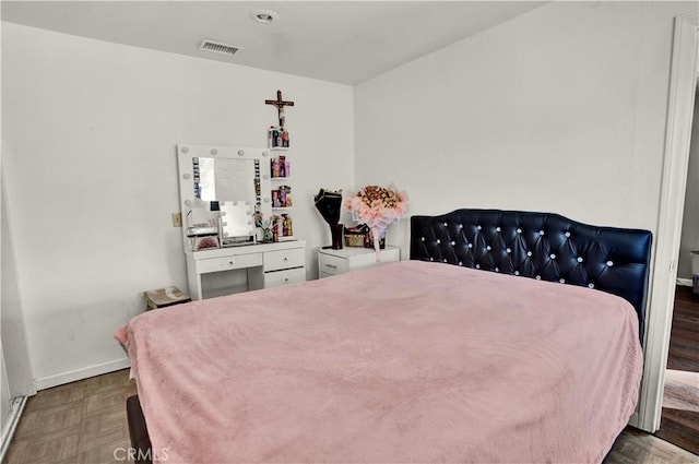 bedroom with dark parquet floors