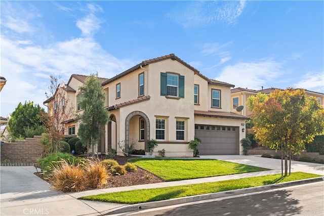 mediterranean / spanish house featuring a front yard and a garage