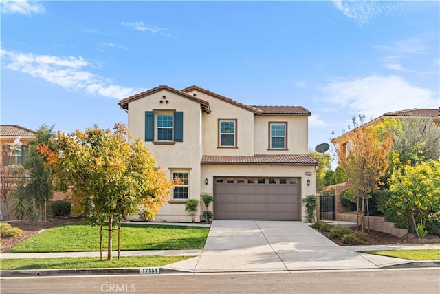 mediterranean / spanish-style house featuring a front lawn and a garage