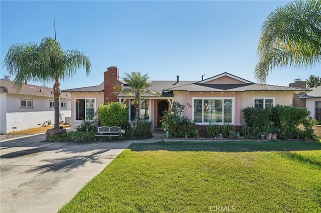 ranch-style home featuring a front yard