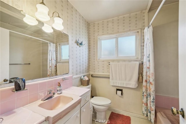 full bathroom featuring shower / bath combination with curtain, vanity, toilet, and backsplash