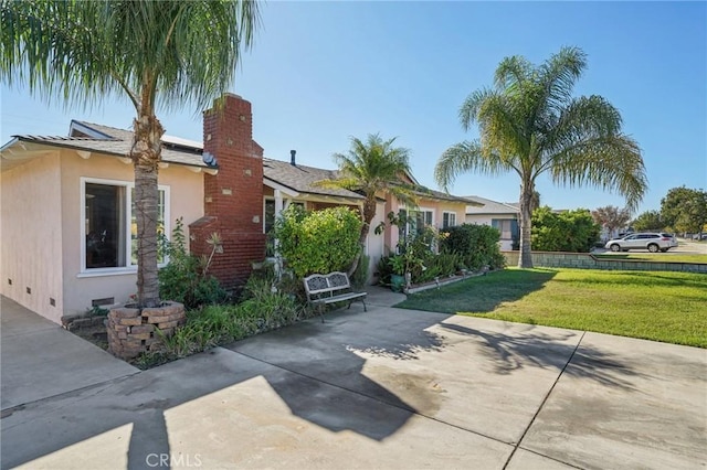 exterior space with a patio area and a front yard