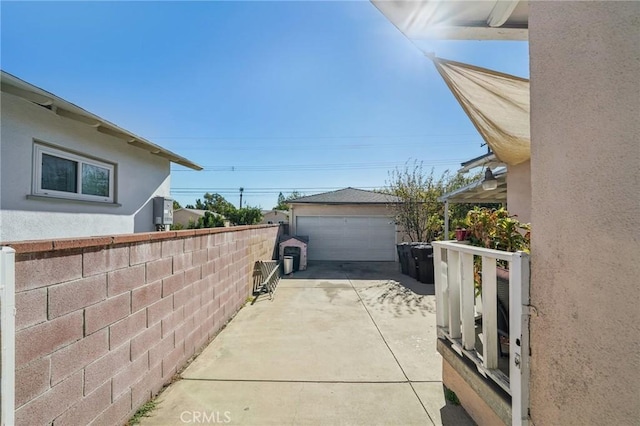 view of patio / terrace with a garage and an outdoor structure