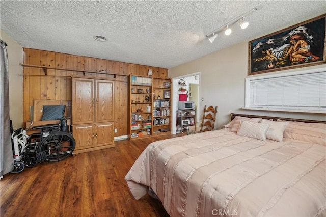 bedroom featuring dark hardwood / wood-style flooring and a textured ceiling