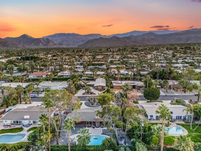 aerial view at dusk featuring a mountain view