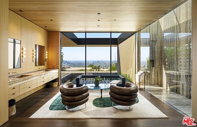 bathroom featuring vanity, expansive windows, wood-type flooring, and wooden ceiling