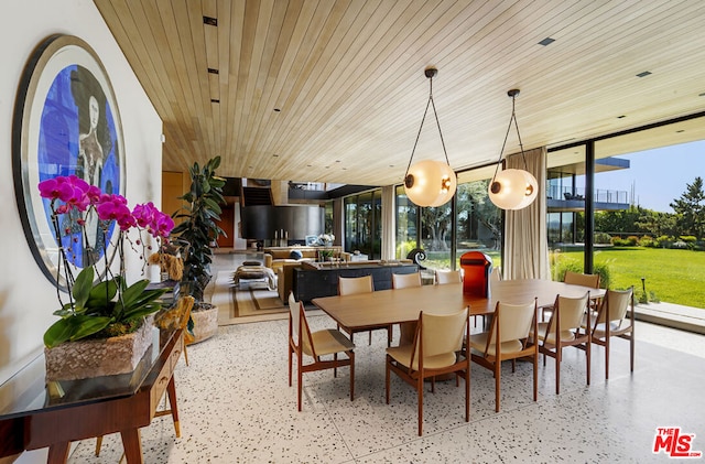 dining space featuring expansive windows, a healthy amount of sunlight, and wood ceiling