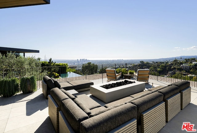 view of patio with a water view and an outdoor fire pit