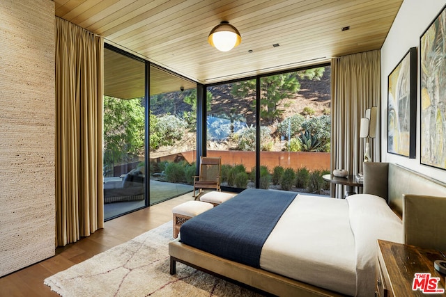 bedroom featuring access to outside, floor to ceiling windows, wooden ceiling, and wood-type flooring