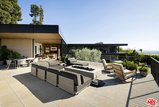 view of patio with ceiling fan and an outdoor living space with a fire pit