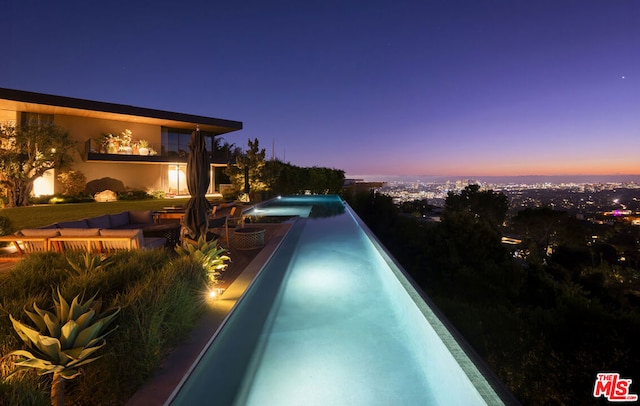 view of pool at dusk