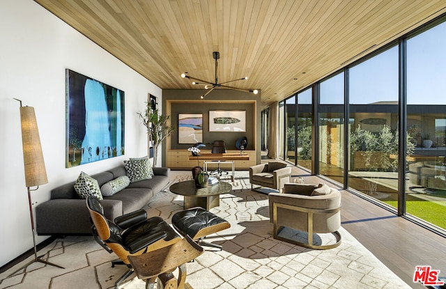 sunroom / solarium with wooden ceiling, a wealth of natural light, and a chandelier