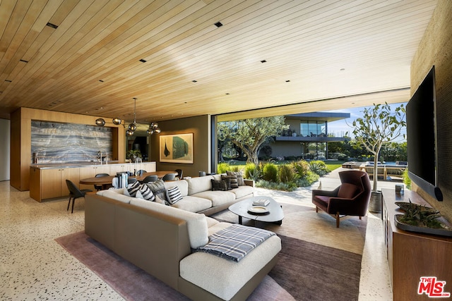 living room with an inviting chandelier, expansive windows, and wood ceiling