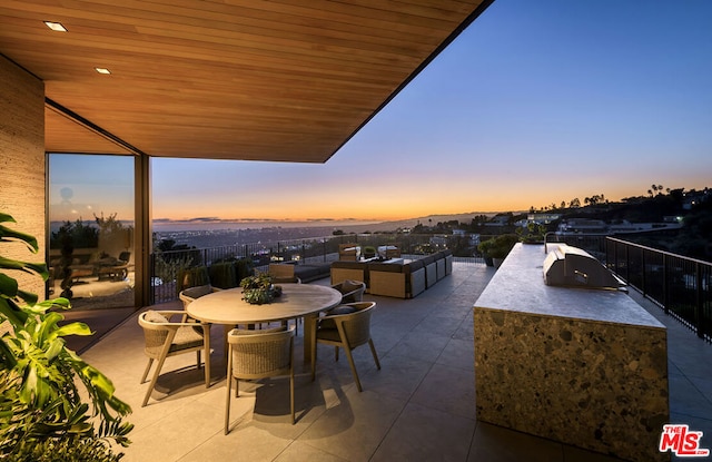 patio terrace at dusk featuring an outdoor hangout area