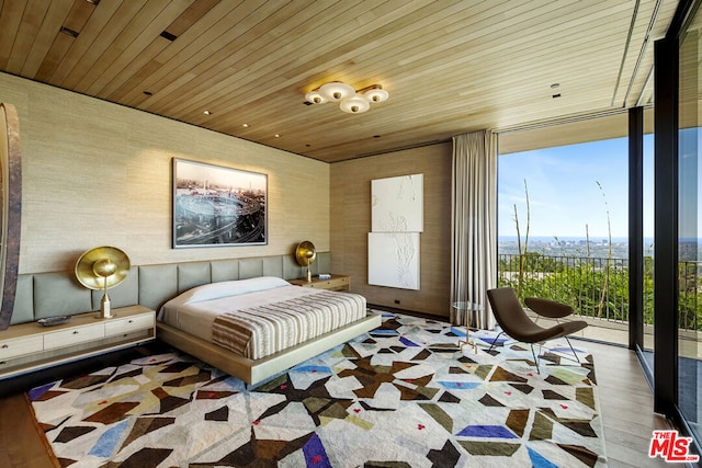 bedroom with hardwood / wood-style floors, expansive windows, and wooden ceiling