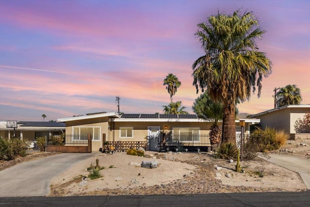 ranch-style home with solar panels