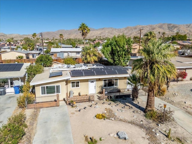 view of front of house featuring a mountain view and solar panels