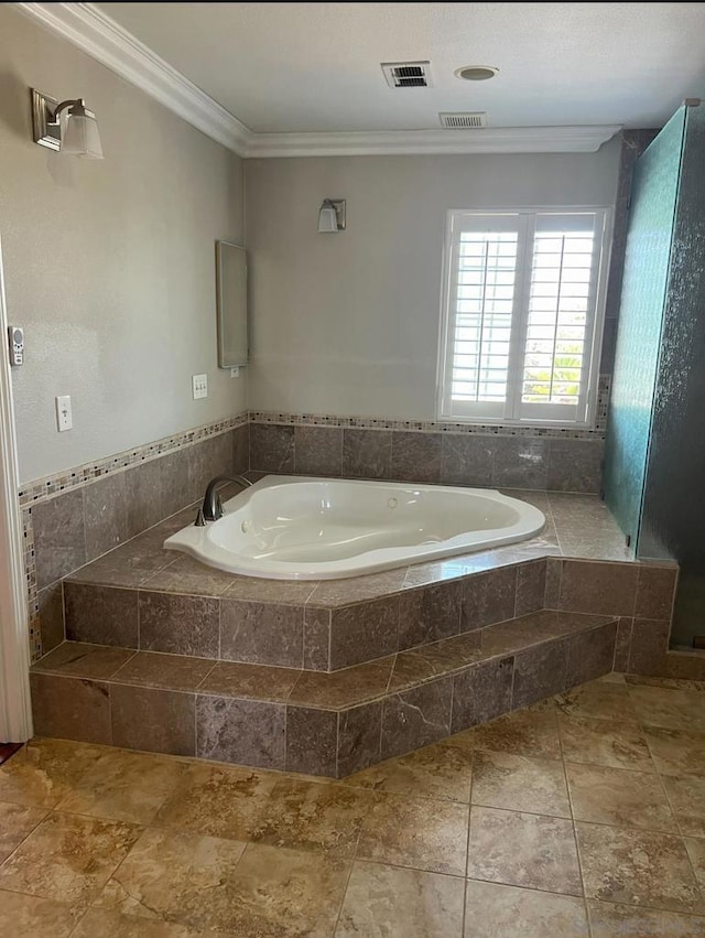 bathroom featuring tiled bath and crown molding