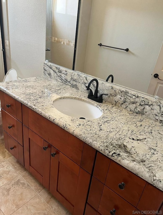 bathroom featuring tile patterned flooring, vanity, and toilet