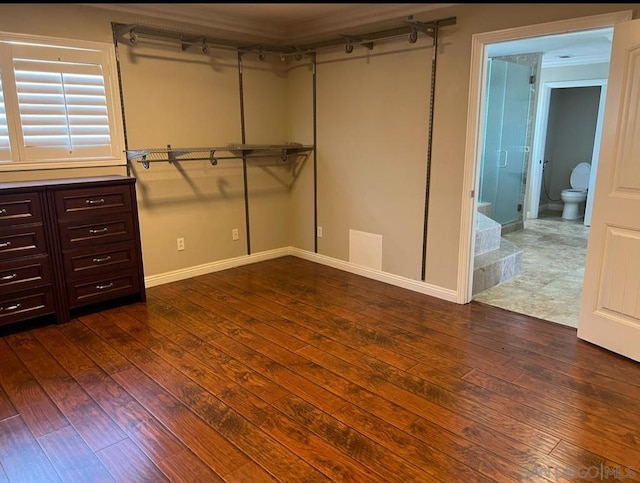 interior space featuring connected bathroom and dark wood-type flooring