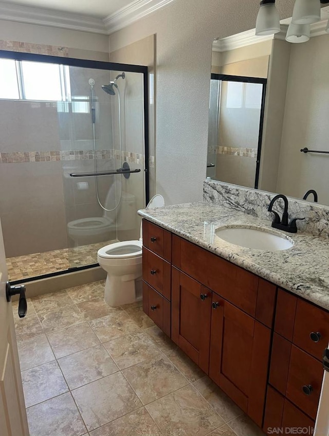 bathroom featuring crown molding, vanity, an enclosed shower, and toilet