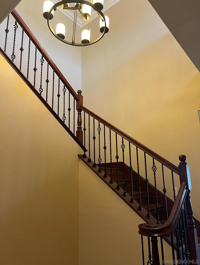 stairway featuring an inviting chandelier