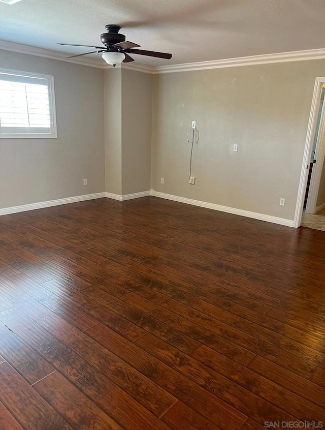 empty room with dark hardwood / wood-style floors, ceiling fan, and ornamental molding