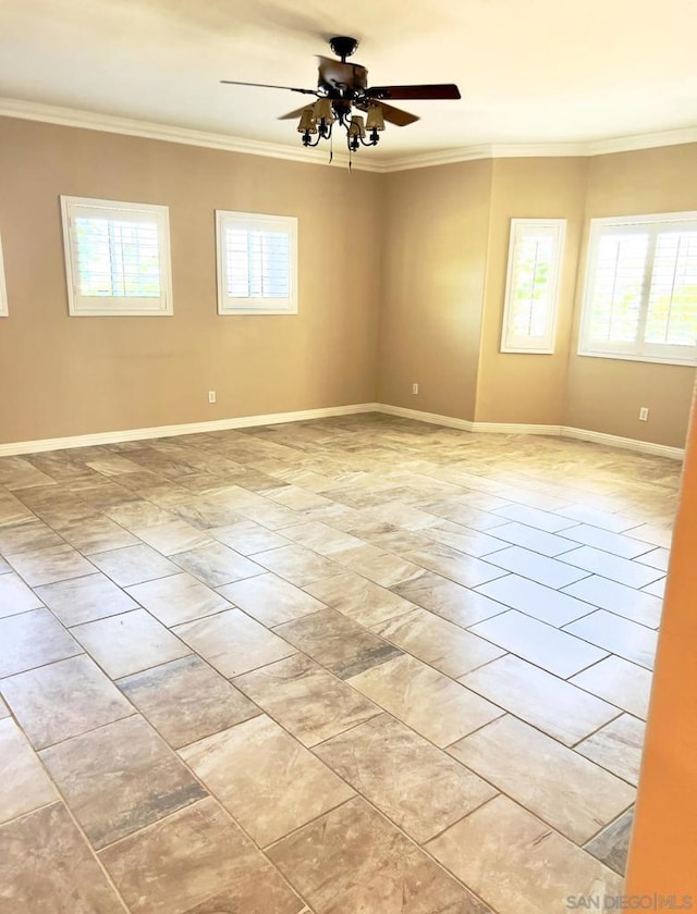 empty room featuring ornamental molding, ceiling fan, and a healthy amount of sunlight