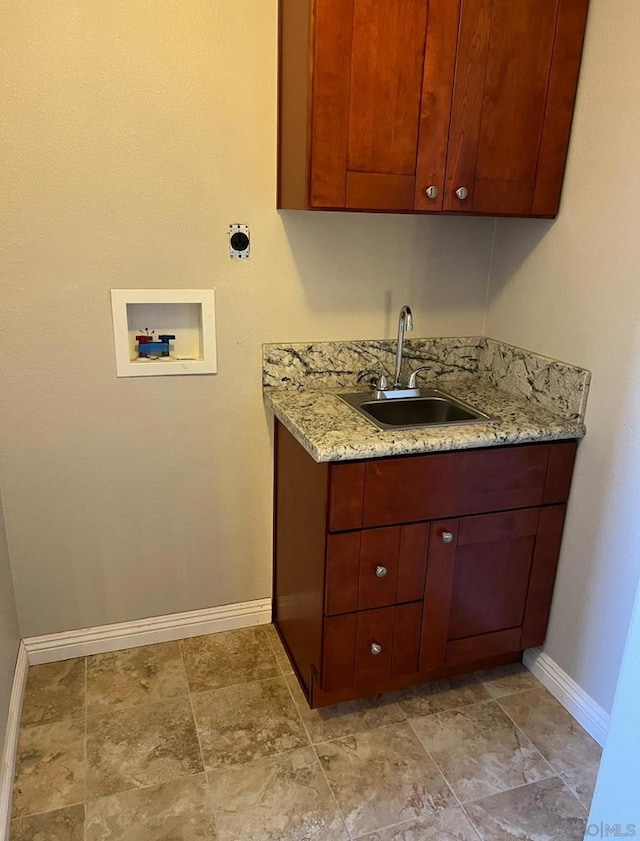 clothes washing area featuring hookup for an electric dryer, cabinets, sink, and hookup for a washing machine