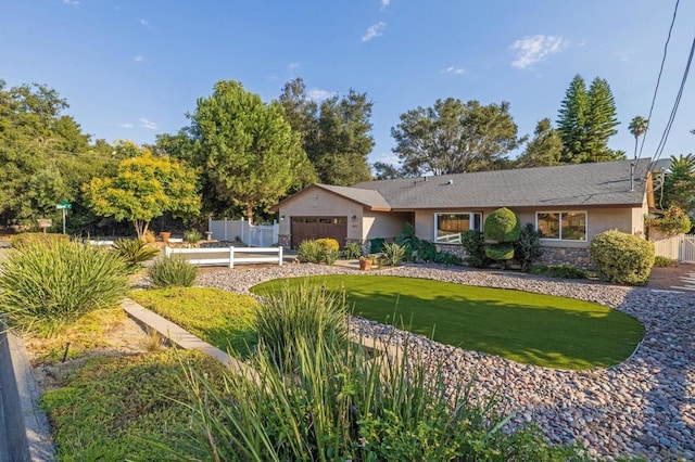 ranch-style home with a garage and a front lawn