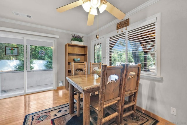 dining area featuring ceiling fan, french doors, crown molding, and hardwood / wood-style flooring