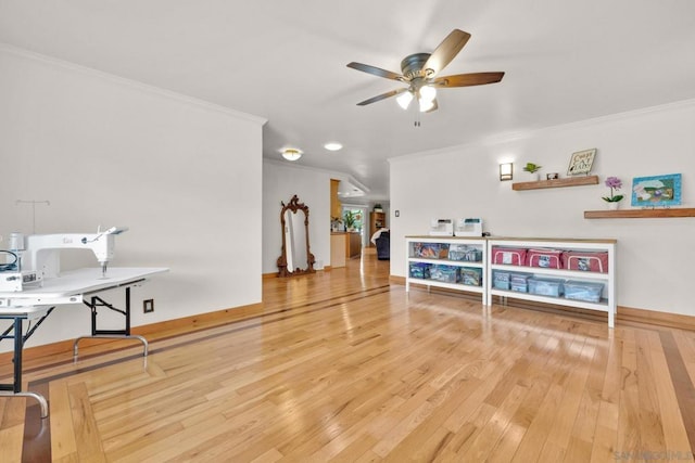 playroom with ceiling fan, ornamental molding, and hardwood / wood-style flooring