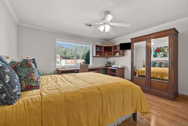 bedroom with light wood-type flooring, ceiling fan, and ornamental molding