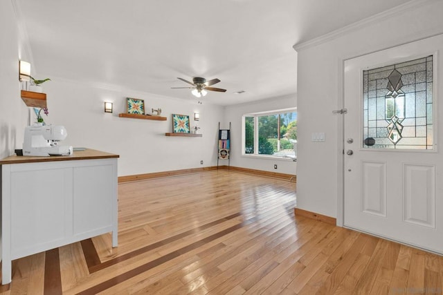 entryway featuring ceiling fan, light hardwood / wood-style flooring, and ornamental molding