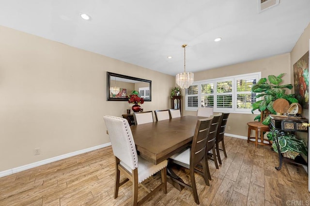 dining room featuring light wood finished floors, baseboards, visible vents, a chandelier, and recessed lighting