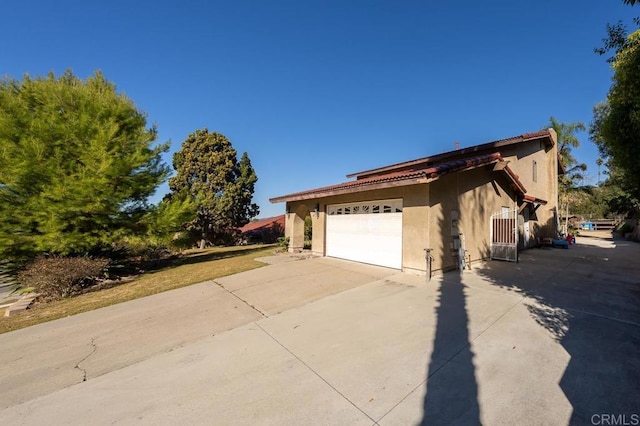 view of home's exterior with driveway and stucco siding