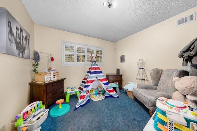 playroom featuring a textured ceiling, carpet floors, and visible vents