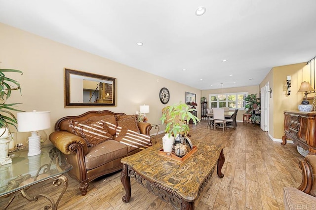 living room with light wood-type flooring, baseboards, and recessed lighting