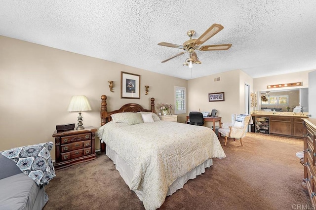 carpeted bedroom featuring a textured ceiling, wine cooler, visible vents, and a ceiling fan