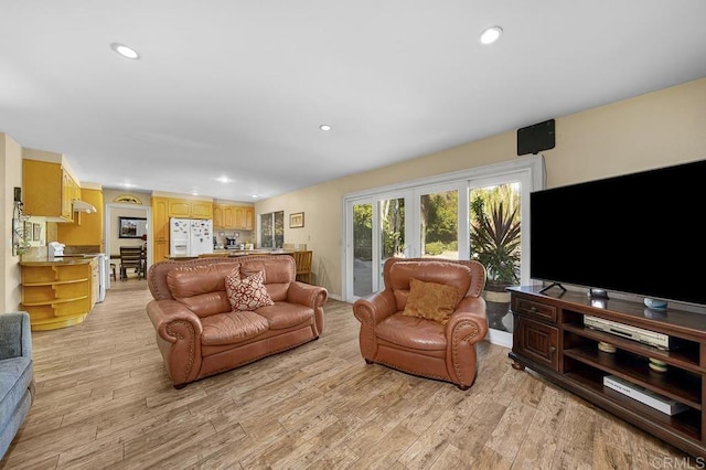 living area featuring light wood-type flooring and recessed lighting