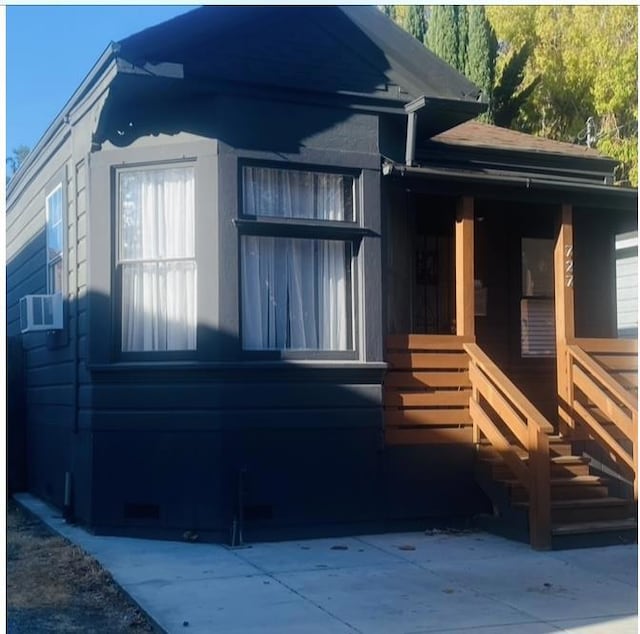 view of side of property with cooling unit